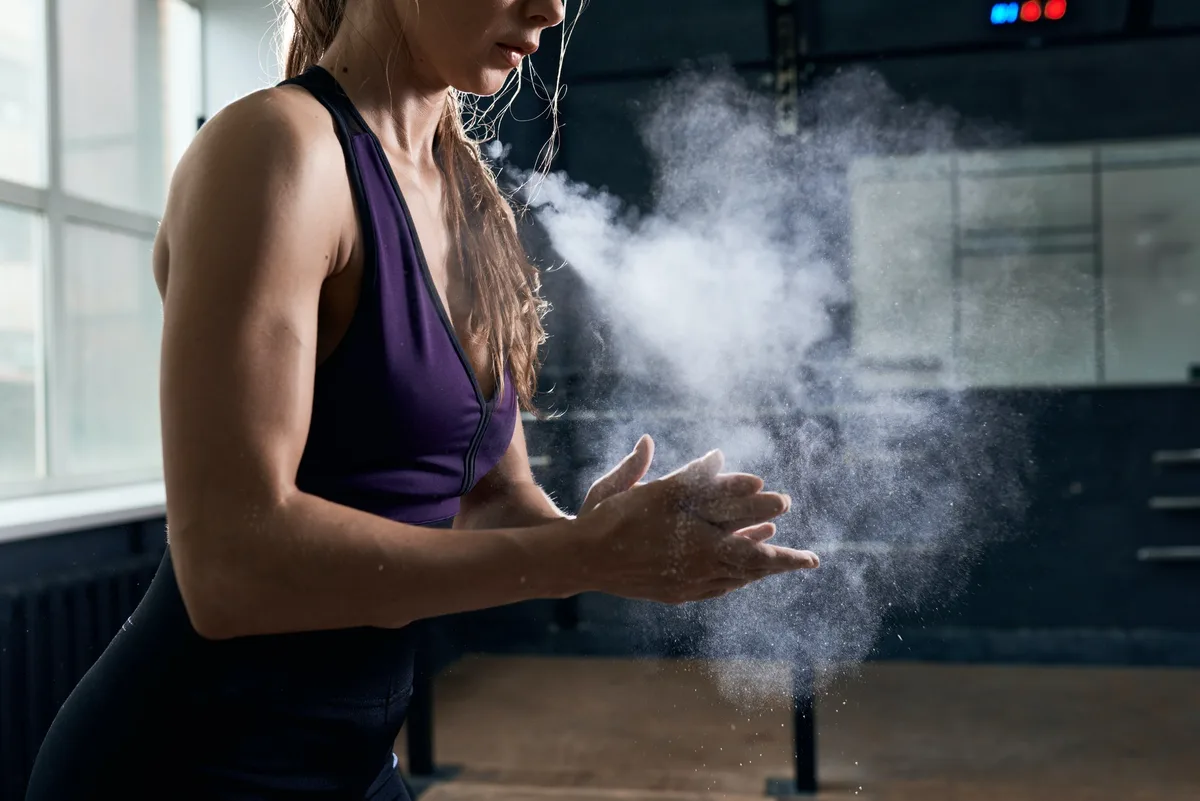 Woman Using Chalk Before Intense Training