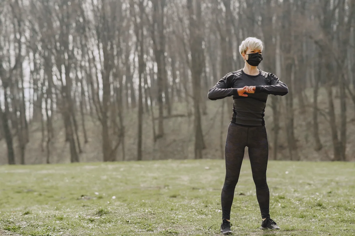 Masked woman training during coronavirus