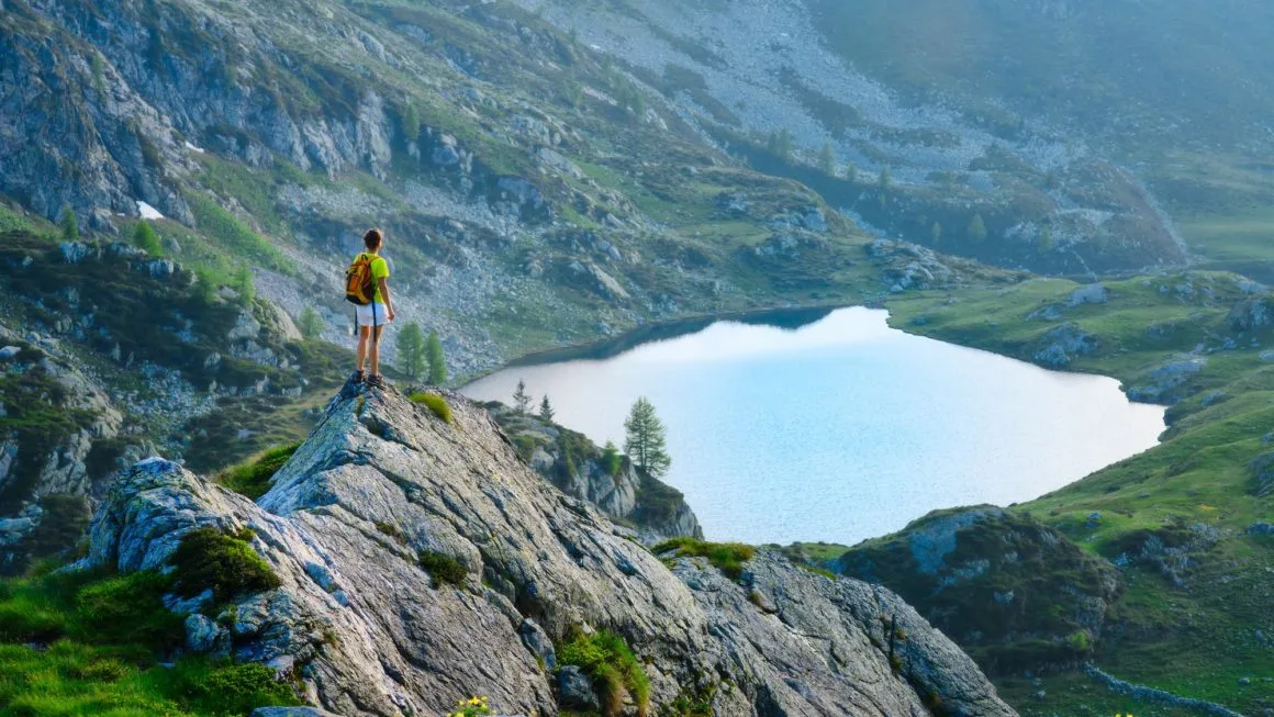 Girl looks mountain lake
