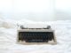 Vintage typewriter on the bed