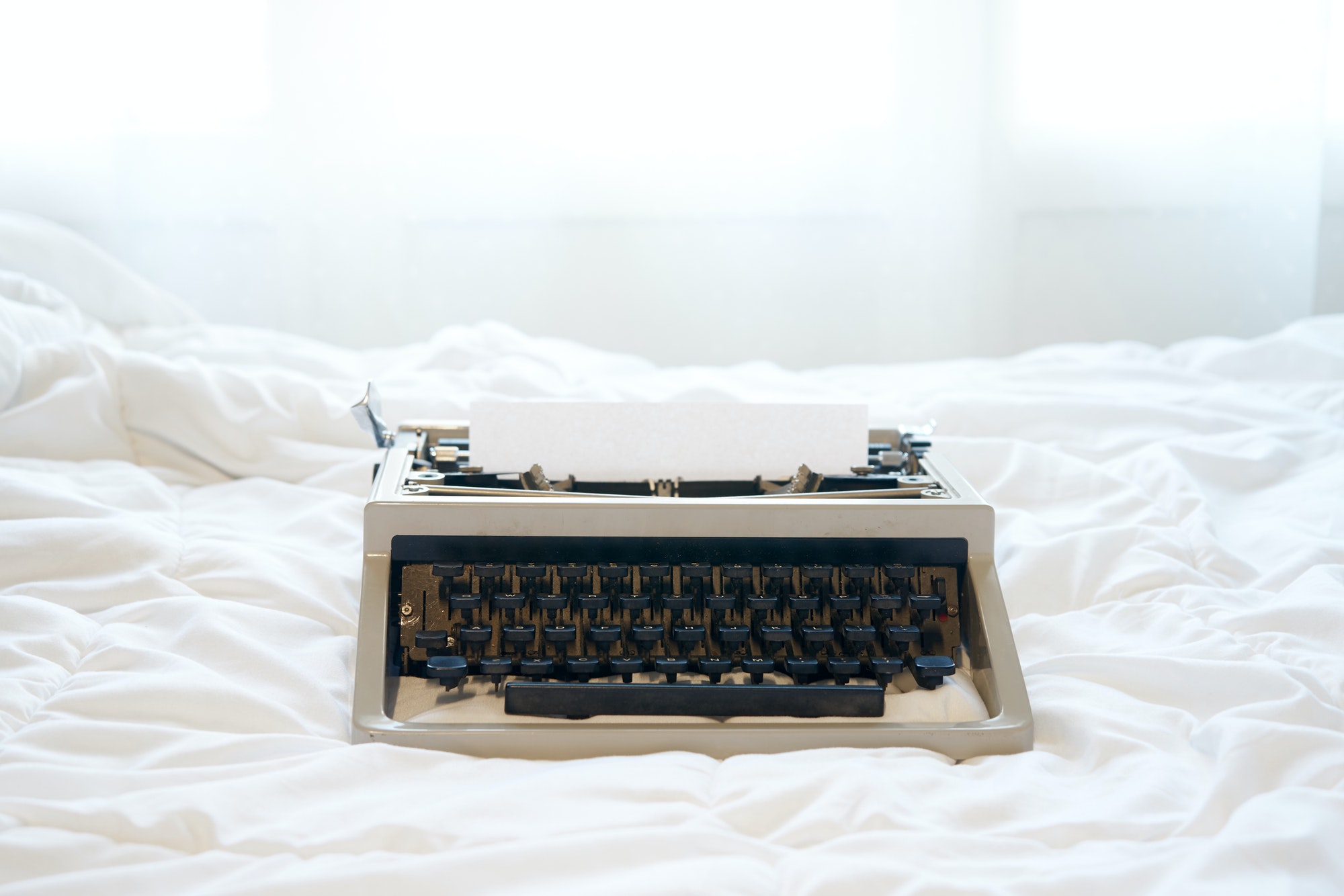 Vintage typewriter on the bed